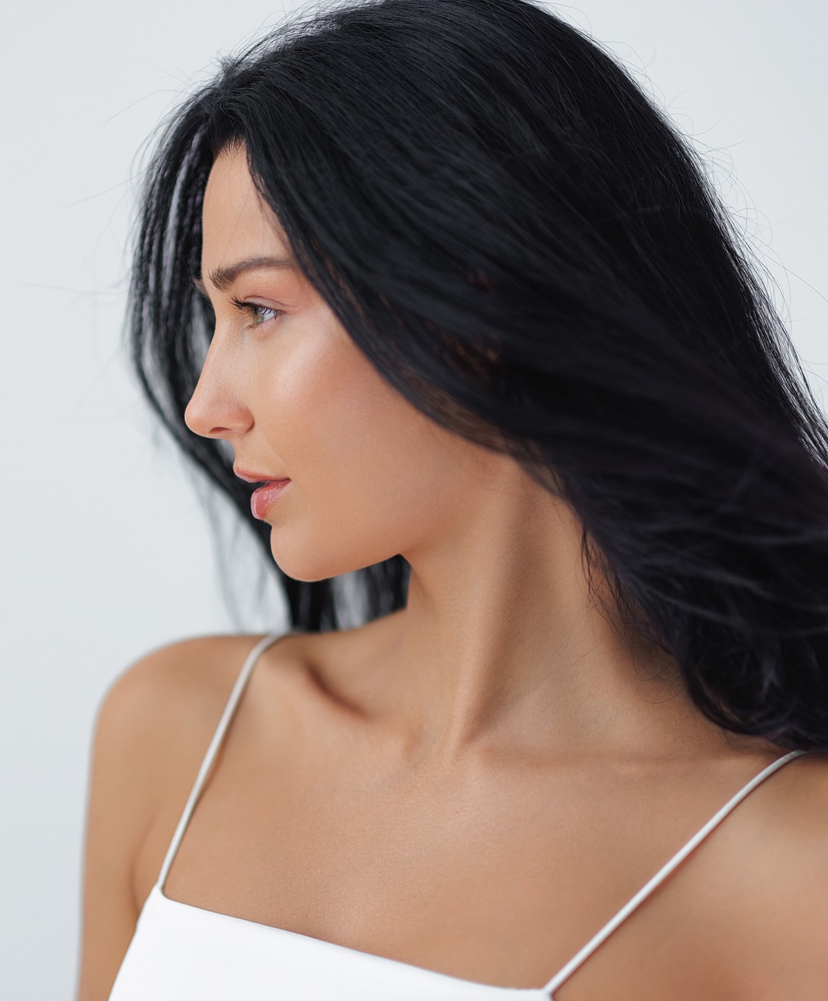 Woman in casual outfit against a neutral background.