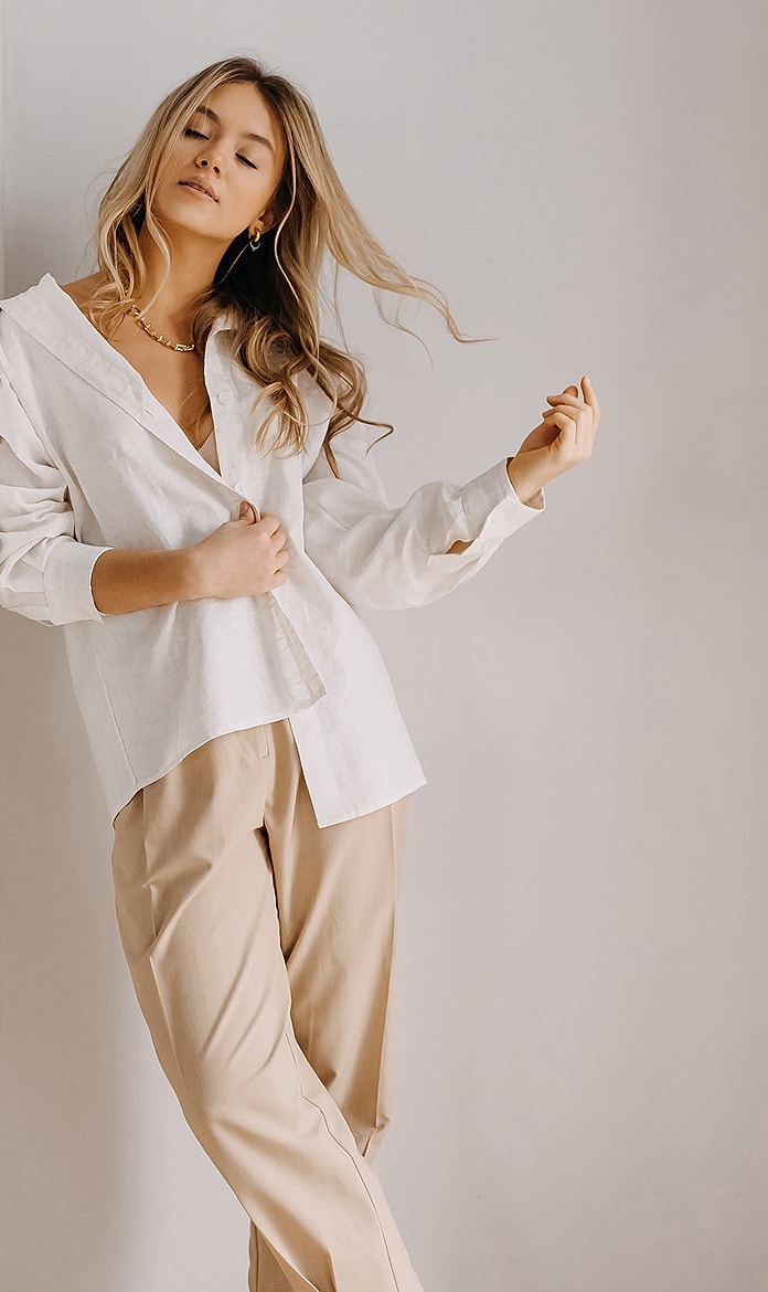 Woman in casual outfit posing confidently indoors.