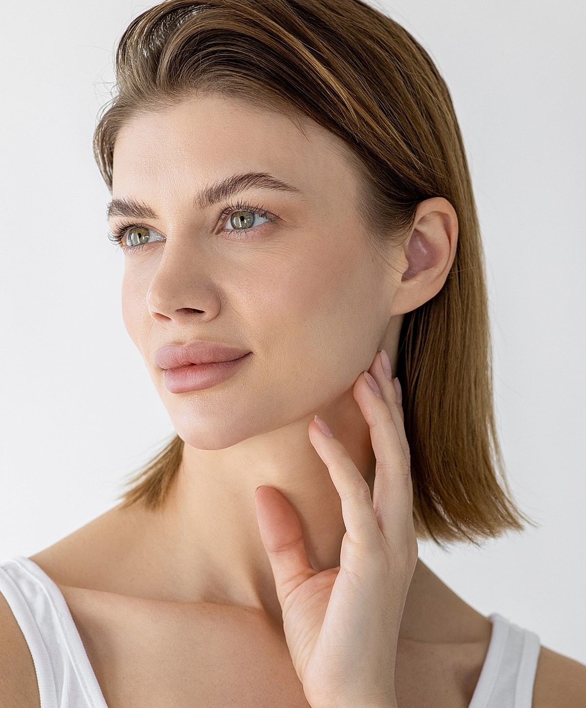 Woman in stylish outfit posing gracefully indoors.