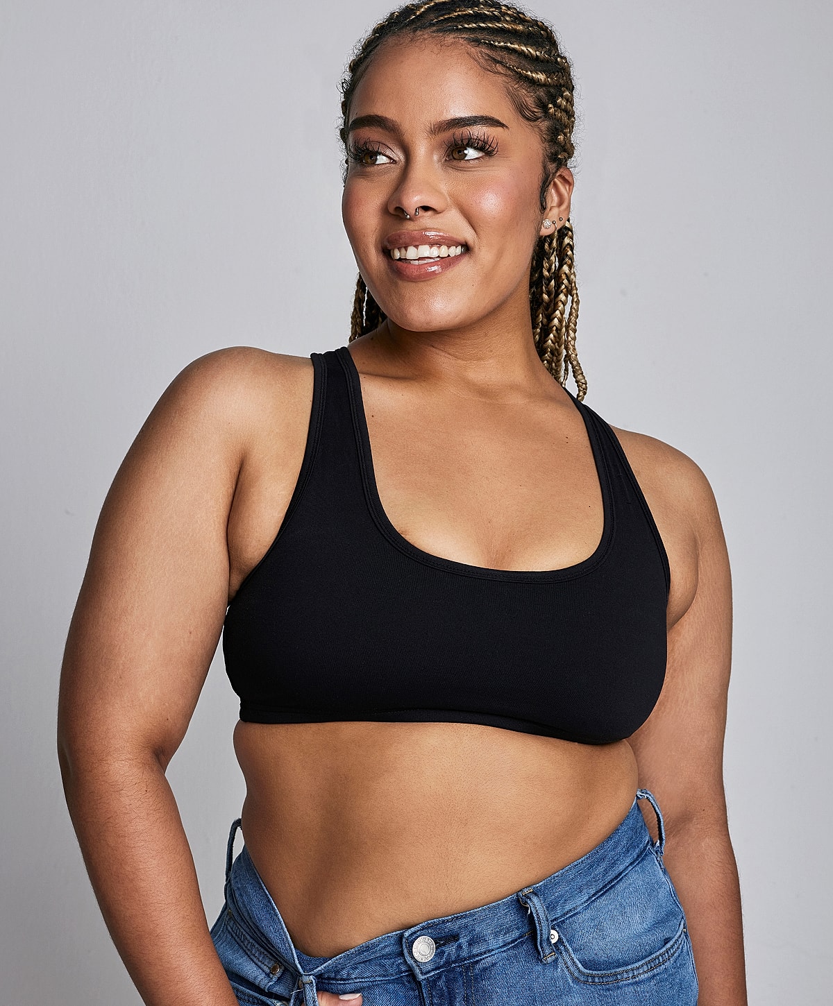 Model posing with hands raised and closed eyes.