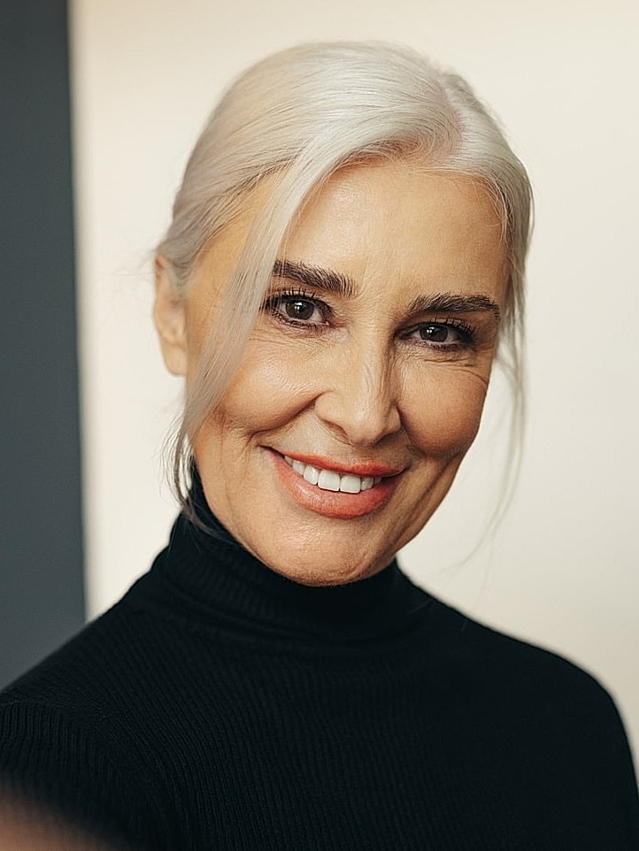 Smiling older woman in black turtleneck sweater.